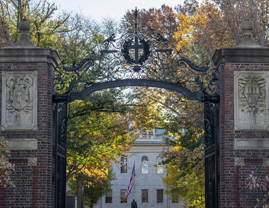 Gates entering Harvard Yard, with a view of University Hall; Autumn trees