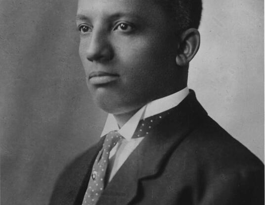 Black and white photo of Harvard PhD alumnus Carter Woodson