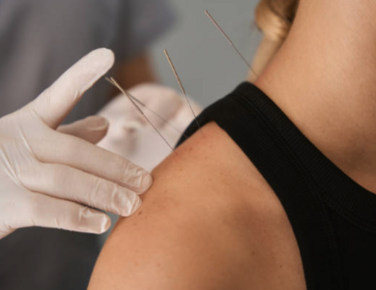 hand wearing gloves doing accupuncture in neck 