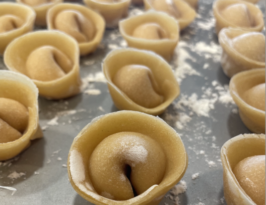 homemade pasta lined up on a pan