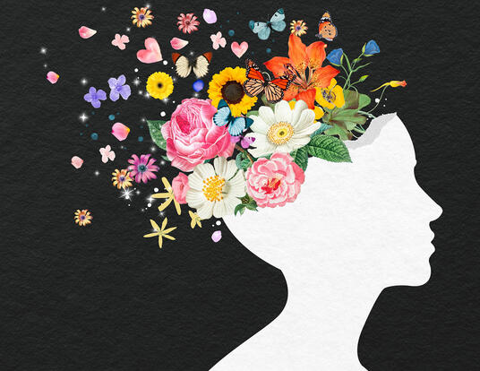 silhouette of face, with flowers and butterflies emerging from top of head, representing positive mental health