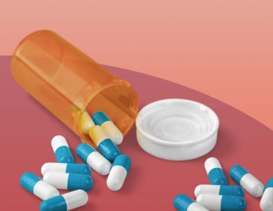 Color illustration of prescription pill bottle overturned with blue and white capsules spilled out.