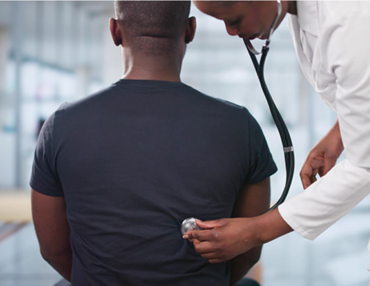 Photo of doctor with a stethoscope examining a patient