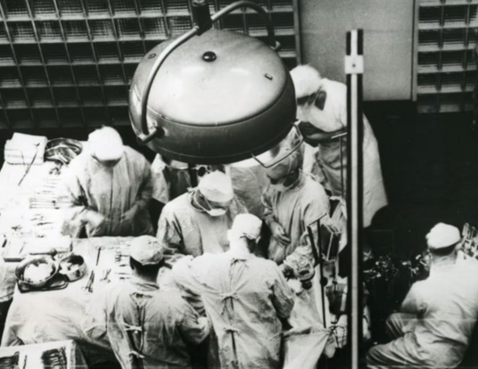 Dr. Joseph E. Murray, at center facing camera, is seen performing the first successful organ transplant on Dec. 23, 1954, at Peter Bent Brigham Hospital in Boston.