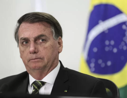 Bolsonaro Marcos Correa with Brazilian flag in back