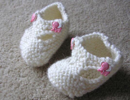Pair of empty white baby booties