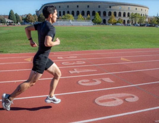 Study co-author Andrew Chin demonstrates the wearable sensors while running on the Harvard McCurdy Outdoor Track. 