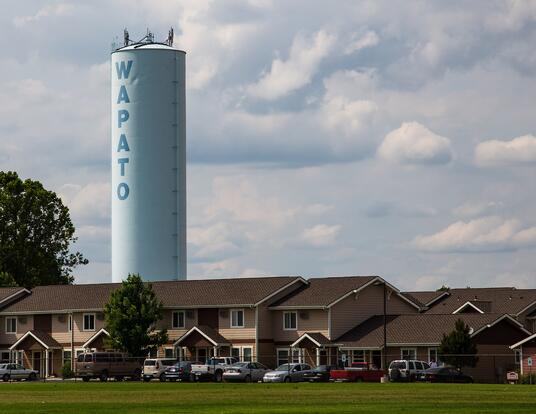 Tower that reads Wapato over rural community in Wapato, Washington