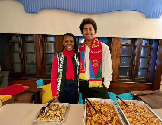 Atte (left) and Isaias (right) organized, “A Taste of Africa,” a food and music sampling event for Perkins residents. Featured dishes, from left to right, are Congolese poulet mayo, sweet fried plantains, and Congolese beignets.