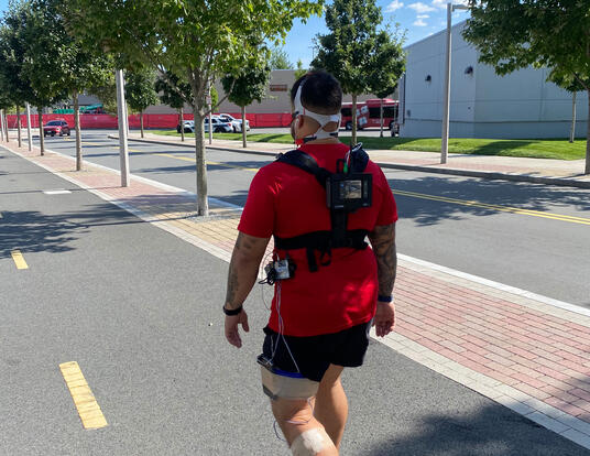 Study participant walking on a bike path to validate the OpenMetabolics model against other, common fitness-tracking systems.