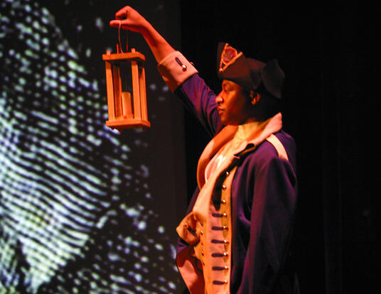 A Soldier dressed in a Revolutionary War period uniform holds a lantern during the Opening Ceremony for the US Army (USA) 31st Signal Symposium Event, at Fort Gordon, Georgia (GA).