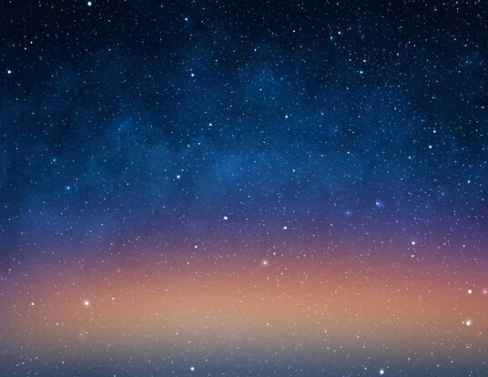 picture of a night sky filled with stars and orange tinted