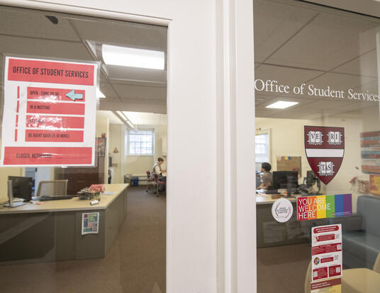 outside door of the Student Services offices with an office sign and You Belong Here sticker