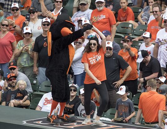 Baltimore Orioles mascot leads fans in a dance