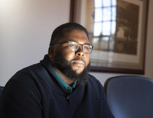 Anthony Abraham Jack leans forward in his chair