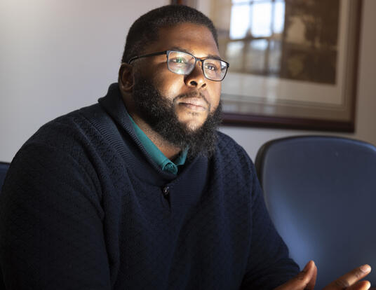 Anthony Abraham Jack leans forward in his chair