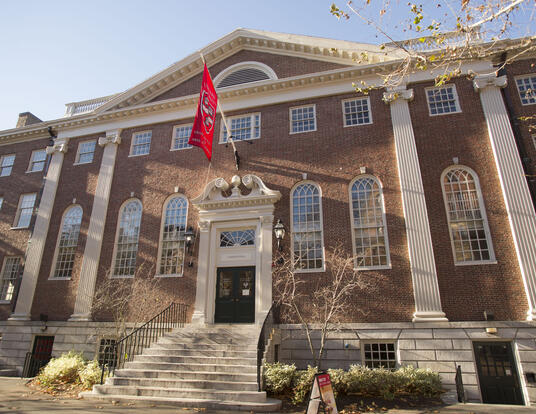 Exterior of Lehman Hall with GSAS flag