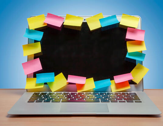 Post-its all over laptop computer