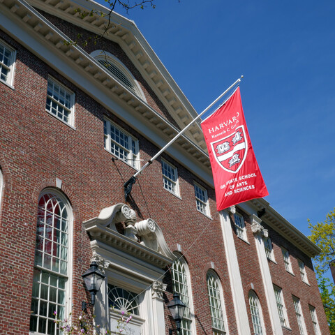 Exterior of Lehman Hall with Harvard Griffin GSAS flag displaying