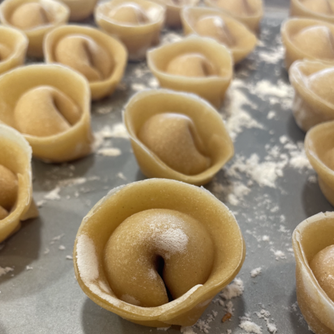 homemade pasta lined up on a pan