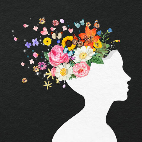silhouette of face, with flowers and butterflies emerging from top of head, representing positive mental health