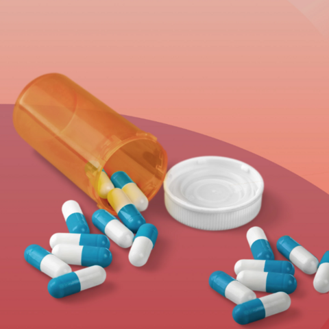 Color illustration of prescription pill bottle overturned with blue and white capsules spilled out.