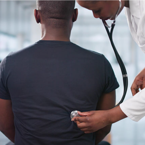 Photo of doctor with a stethoscope examining a patient