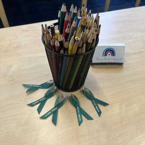 Green mental health awareness month ribbons at the CAMHS front desk
