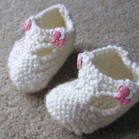 Pair of empty white baby booties