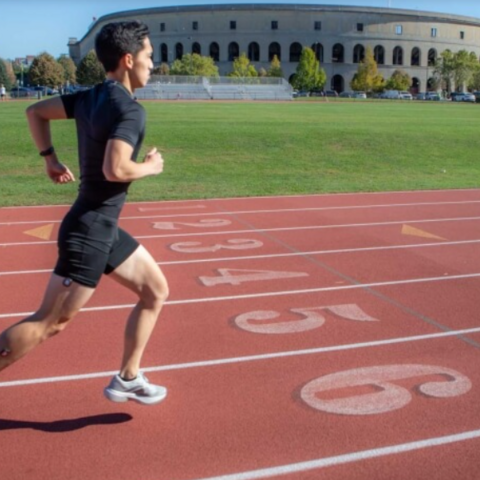 Study co-author Andrew Chin demonstrates the wearable sensors while running on the Harvard McCurdy Outdoor Track. 