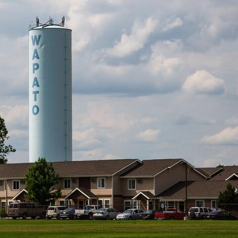 Tower that reads Wapato over rural community in Wapato, Washington