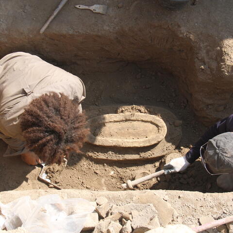 Melina excavating in a trench