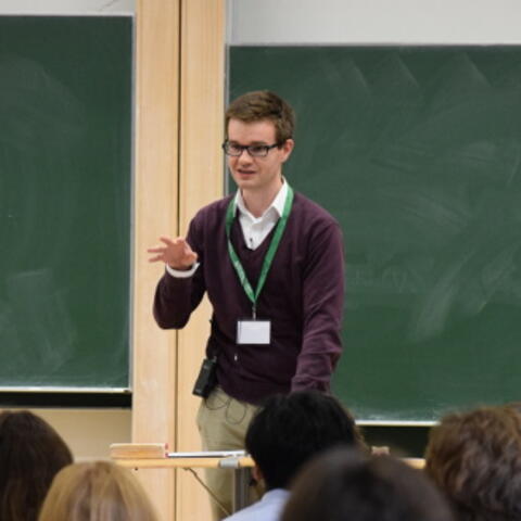 Jack Thorne, Kuwait Professor of Number Theory and Algebra at the University of Cambridge, and a Fellow of Trinity College, speaking in front of a classroom of students