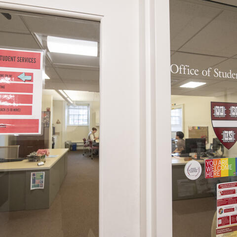 outside door of the Student Services offices with an office sign and You Belong Here sticker
