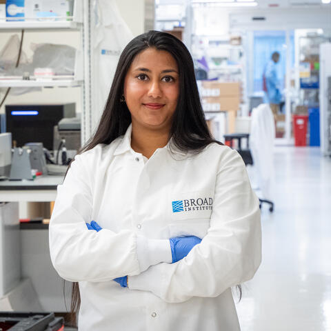 Arya in her white lab coat in the lab at the Broad Institute