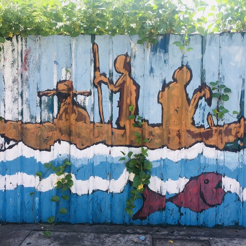 Street art depicting people at sea in a boat in Mahé, Seychelles