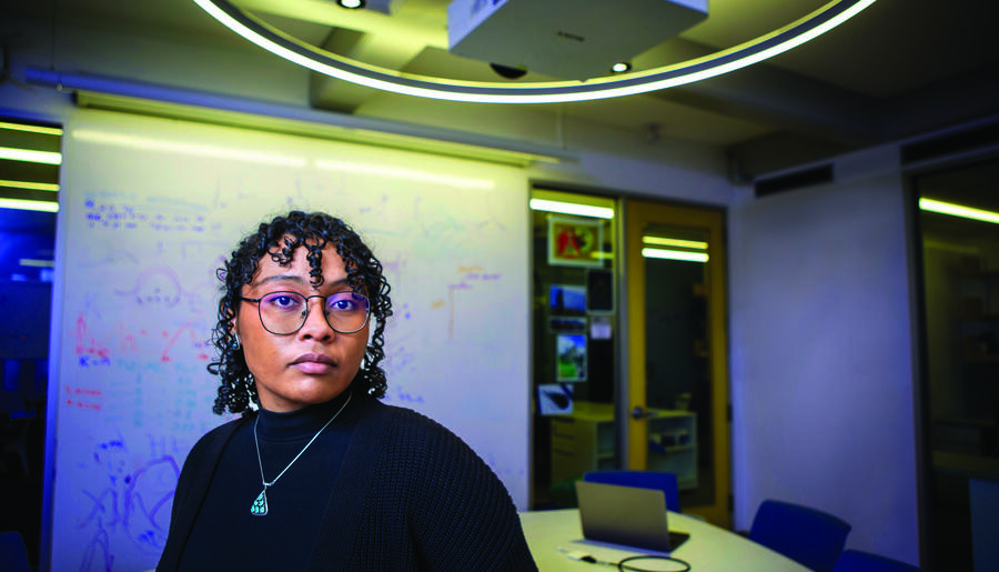 Student Roslyn Curry in front of white board with equations