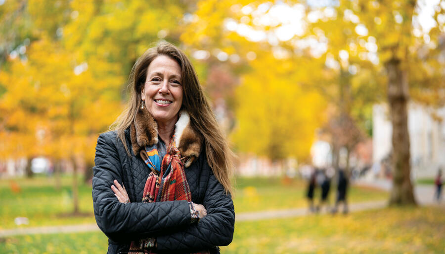 Jill Kastner in Harvard Yard; fall foliage in background
