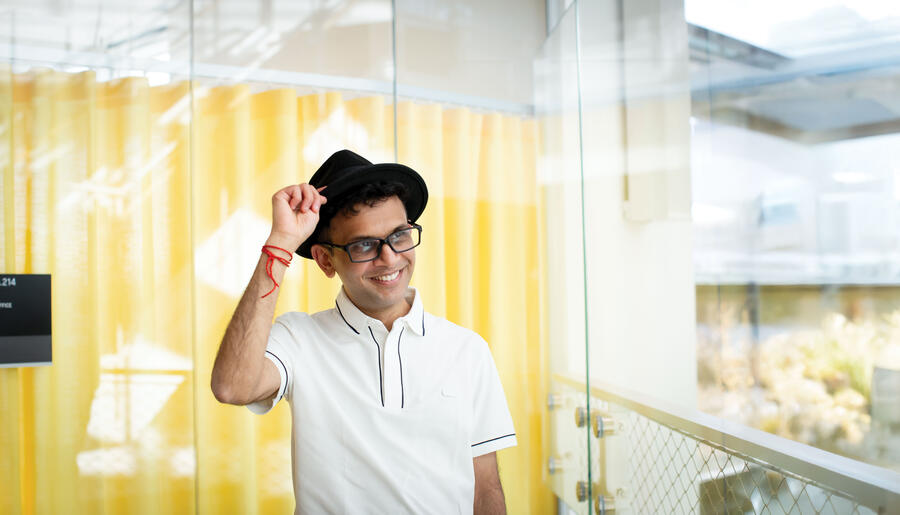 Rohan Murty tipping his black hat and smiling