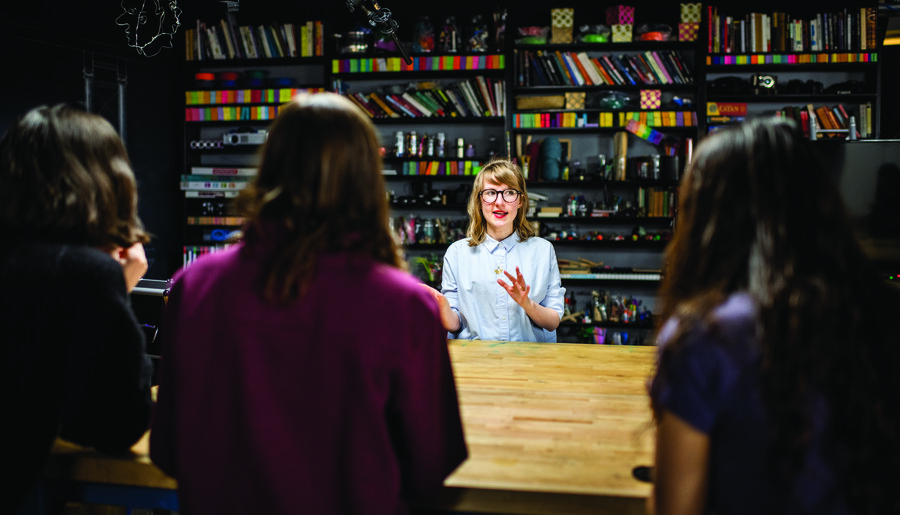 Woman presenting at a wood table