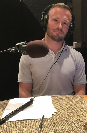 Ben Bellet in the studio recording the podcast