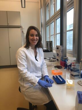 Megan Michel seated in a lab coat