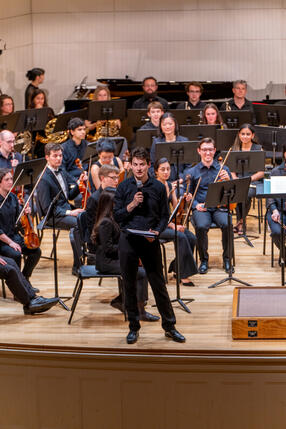 Leo Sarbanes on stage as he conducts the orchestra