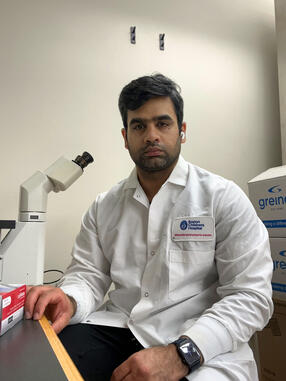 Muhammad Ahmad working in a cell culture lab 