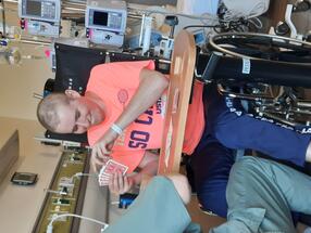 playing cards in a hospital with a therapist sitting in a chair