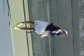 Kozlowski hits a serve in a match for the University High School team in Irvine, CA, 2016.