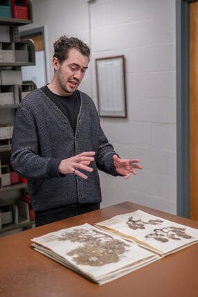 Daniel Faccini standing in front of documents