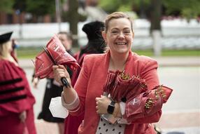 Janet smiling and holding a GSAS flag