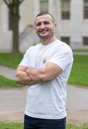 Yazan Alwadi in white t-shirt and arms crossed
