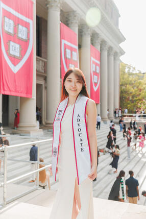 Roka in regalia on the steps of Widener Library